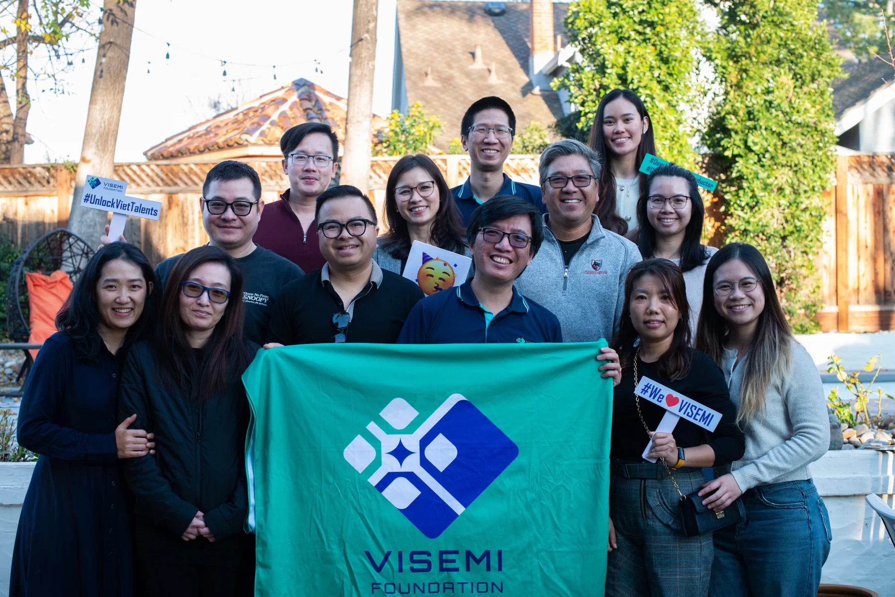 The VISEMI Foundation team gathered with the foundation banner at a community event in Silicon Valley