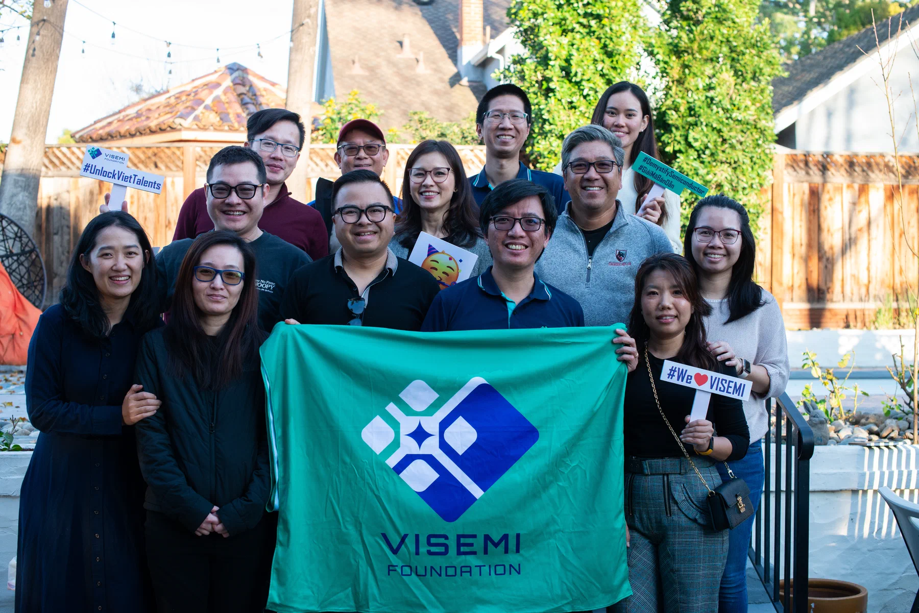 The VISEMI Foundation team gathered with the foundation banner at a community event in Silicon Valley